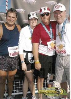 Kelly, second from left, with Rick, second from right, after completing the Disney Half Marathon in 2005.