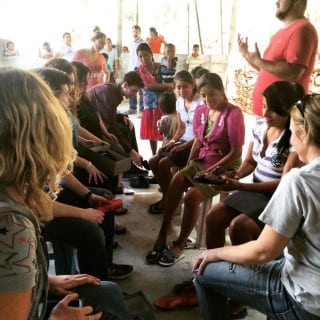 Stan's and Soles4Souls fit shoes on their visit to a Guatemalan community.